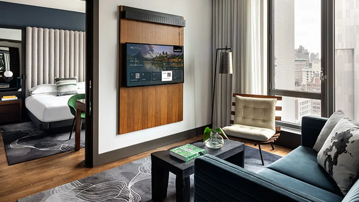 A QR code is displayed on a guest room TV.
