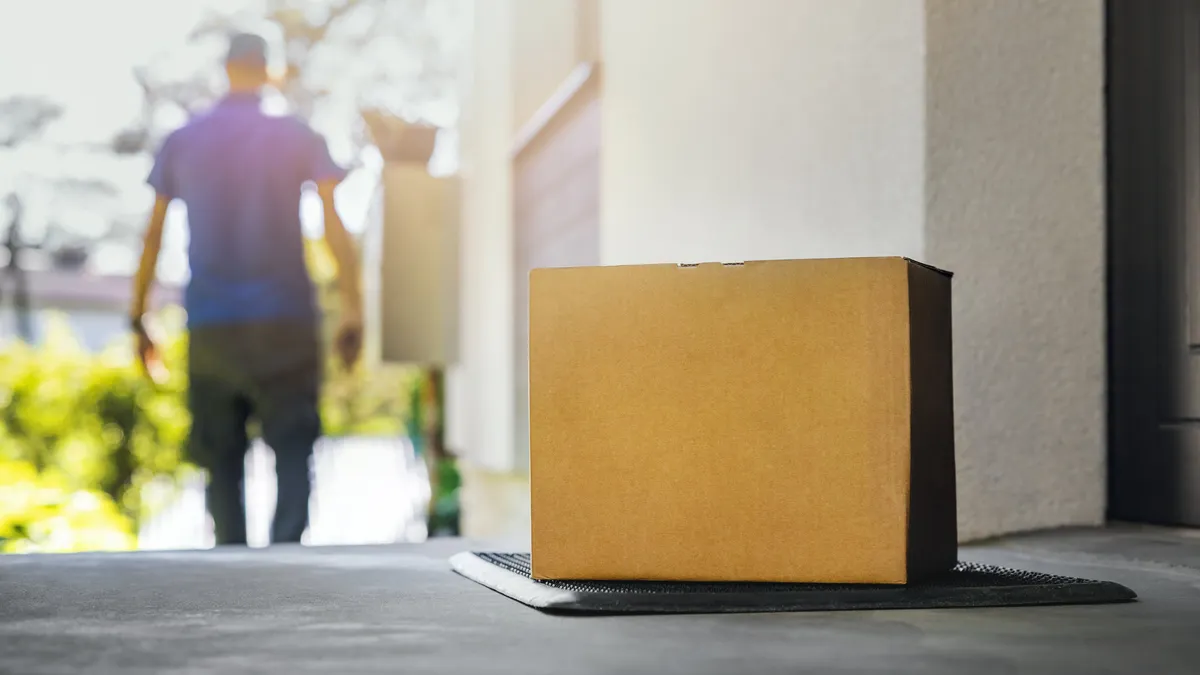 blank shipping box on the house porch. home delivery service